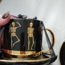 Load image into Gallery viewer, Halloween Elegance Black + Gold Whimsical Skeletons Posing Coffee Tea Cups + Saucers, Set2