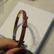 Load image into Gallery viewer, Kate Spade Take a Bow Enameled Bracelet in Rose Gold and Sparkling Pink