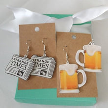 Load image into Gallery viewer, Strange Times Newspaper + Frosty Beer Mug Earrings, set of 2
